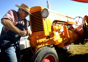 Monte Soukup of Lawrence turns the crank on his 1945 model Minneapolis Moline model U tractor during the educational day at the Central Kansas Flywheels Yesteryear Museum on Friday, Oct. 9, 2010. . (photo by Jeff Cooper/ Salina Journal)